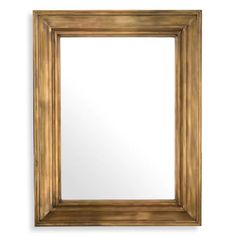 a gold framed mirror on a white wall