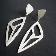 Sterling Silver Statement Earrings Triangle Geometric Cut-Out Modern Handmade Geometric Earrings, Handmade Modern Geometric Earrings, Modern Teardrop Plug Earrings As Gift, Modern Teardrop Earrings For Gift, Modern Teardrop Plug Earrings For Gift, Modern Drop Earrings With Unique Design, Modern Handmade Sterling Silver Plug Earrings, Handmade Modern Sterling Silver Plug Earrings, Modernist Drop Earrings As A Gift