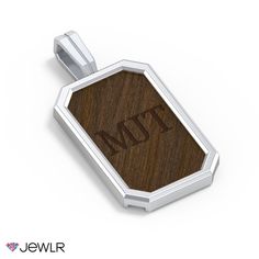 a wooden and silver pendant with the word mtt on it's front side