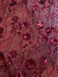 pink sequins and beads on wood floor