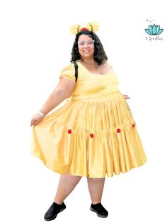 a woman in a yellow dress and black shoes posing for the camera with her hands on her hips