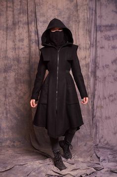 ♥ EXPRESS worldwide shipping - buy your favorite piece today and wear it within just 1-3 days upon shipping ♥ This black winter coat with a zip-up face shield will keep you safe and cozy! With its shoulder accents and waist belt the coat is extremely flattering to any body shape! The black bandana face mask is not included in the price, you can find it as a separate item here: https://www.etsy.com/listing/795188463/face-mask-washable-neck-gaiter-mask?ref=shop_home_active_4&pro=1 ♥ Material: Goth Winter Coat, Black Techwear Parka For Fall, Cosplay Winter Outerwear With Adjustable Hood, Black Combat Style Outerwear With Pockets, Military Style Winter Outerwear For Cosplay, Military Style Outerwear For Winter Cosplay, Black Hooded Jacket With Stand Collar For Fall, Fitted Black Military Outerwear, Black Fitted Military Outerwear