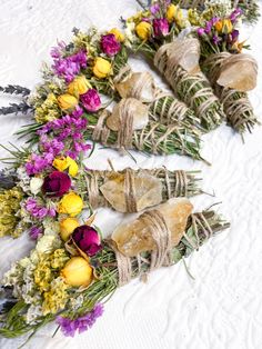 dried flowers are arranged on the snow covered ground