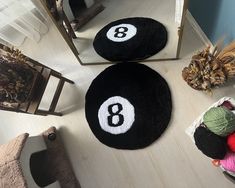 two black and white round rugs with numbers on them in front of a mirror