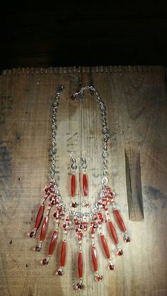 The rich in color Carnelian beads in this design are fabulous. They're such a unique style of bead and in combination with the hand blown Artisan Glass beads they create a true one of a kind design. This is absolutely a statement bib piece that includes matching earrings. **Talk about a bright silver & red kind of statement bib necklace. Pop this baby on just about any outfit and you'll been seen even in the largest group of people! This bright silver chain necklace is shy of 18'' long before the sterling lobster clasp and 2'' extender chain. One of the beauty's of this piece is you can wear it closer to your neck or as a choker if you want because of the lobster clasp and room in the chains links are easy to clip it into.   * **Made up with 9 fabulous, long, rich in color... faceted Carne Red Polished Beads Jewelry Sets, Red Jewelry Sets With Polished Round Beads, Red Agate Beaded Necklaces With Round Beads, Red Dangle Jewelry With Faceted Beads, Oval Glass Gemstone Beads Jewelry, Red Agate Beaded Necklace With Gemstone Beads, Adjustable Red Jewelry With Dangling Beads, Red Carnelian Artisan Necklace, Elegant Red Necklace With Dangling Beads