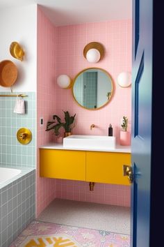 a bathroom with pink tiles and yellow cabinets