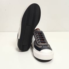 This leather lace up sneaker has been handcrafted from flawless grain leather, embellished with a leather insole that nods to the brand's heritage. Perfectly paired with tailored suits and leather jackets. Leather Lining for a luxurious feel and moisture control Leather collar and tongue Rubber sole Tapered round toe. The handmade sustainable Gommus rubber outsole and insole are Made in Italy. STYLE #D2168T Navy Leather Lace-up Sneakers, Classic Navy Sneakers With Contrast Sole, Navy Leather Custom Sneakers For Streetwear, Classic Navy High-top Sneakers, Navy Sneakers With Contrast Sole And Round Toe, Navy Sneakers With Contrast Sole, Navy Leather Sneakers For Streetwear, Navy Custom Sneakers With Contrast Sole, Navy Sneakers With Rubber Sole And Round Toe