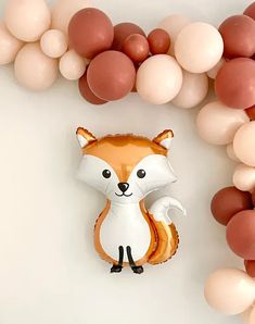 a balloon shaped like a fox surrounded by balloons