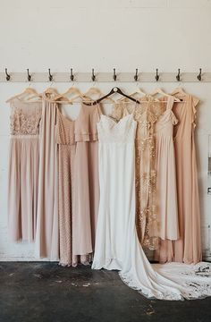 the bride's dresses are hanging up in her bridal suite