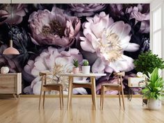 a dining room table with two chairs next to a large floral wall mural on the wall