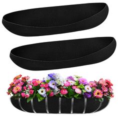 three black flower boxes with flowers in them