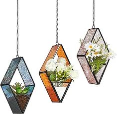 three hanging planters with flowers and plants in them, one is shaped like a diamond