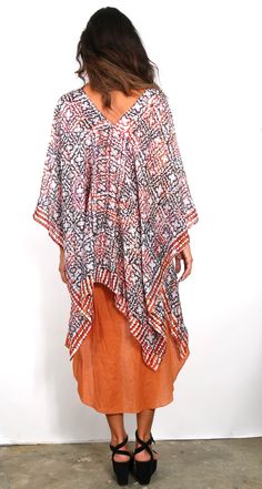 Our best seller know as our “ Poncho” is a very easy to wear shape. It has open sides, a neckline in the center and can be worn many ways and is the ESSENTIAL Travel Must have item! The poncho can be worn many ways such as shown, or as a scarf, wrap around your hip, one shoulder over a dress, and has many multi functions (see chart of many ways to wear). It’s the must have beach cover up and also looks great over jeans. We suggest you wear it on the plane to keep warm while traveling and this wa One Size Wrap Top For Beach, Summer Lagenlook Blouse For The Beach, Lagenlook Summer Blouse For The Beach, Summer Beach Blouse Lagenlook Style, Spring Batik Print V-neck Kaftan, Bohemian Printed Open Front Tops, Bohemian Open Front Printed Tops, Oversized Versatile Blouse For Beach, Casual Summer Kimono With Batik Print