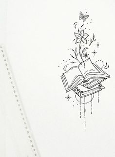 an open book sitting on top of a table next to a pen and ink drawing