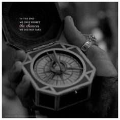 a person holding a compass in their hand with a quote on the inside of it