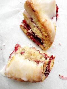 two pastries sitting on top of each other with icing and crumbs