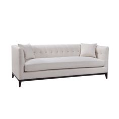 a white couch with black legs and buttons on it's back end, against a white background