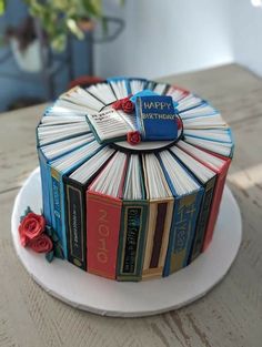 a birthday cake made out of books on a table