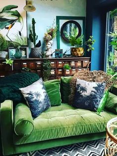 a living room filled with green couches and lots of plants on top of them