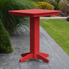 a brown table sitting on top of a brick walkway