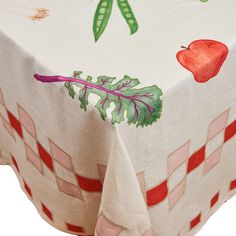 the table cloth has an apple and leaf design on it