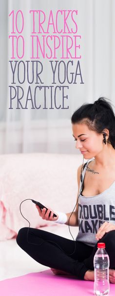 a woman sitting on the floor listening to music with headphones and holding a cell phone