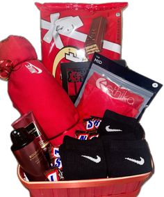 a red basket filled with lots of items like socks, mitts and other things