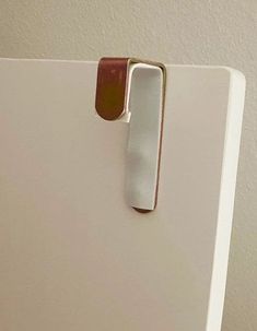 a close up of a white refrigerator door handle