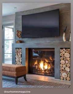 a living room with a fire place and television on the wall above it's fireplace