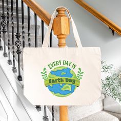 a canvas bag with the words every day is earth day on it hanging from a banister