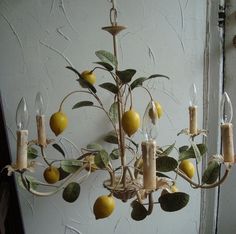 a chandelier with lemons hanging from it