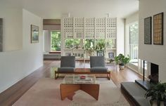 a living room filled with furniture and a fire place in the middle of a room