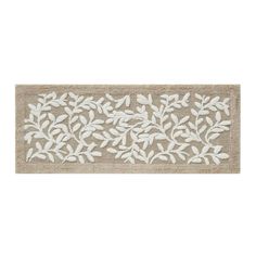 a door mat with white leaves on the front and bottom, along with a beige background