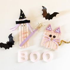 popsicle halloween decorations made to look like witches and bats with the word boo spelled out