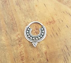 This elegant ethnic boho nose ring septum is totally made by hand of sterling silver, it can be wear as a single earring as well. Septum piercing made of sterling silver very unique and stylish perfect for tattoo lovers or girlfriend gift. Perfect for wear all day long in any ambient, very stylish and quirky but discreet at the same time. It has a very safe and almost invisible closure. SIZE: 12 mm x 15 mm. Please check the shipping policies and shipping times for your destination!! SHIPPING: I Handmade Silver Nose Rings, Small Hoop Silver Septum Ring Nickel Free, Bohemian Sterling Silver Cartilage Earrings For Festivals, Bohemian Sterling Silver Body Jewelry, Handmade Sterling Silver Nose Rings, Silver Single Earring For Festivals, Bohemian Sterling Silver Nose Rings As Gifts, Small Hoop Sterling Silver Nose Rings, Bohemian Hoop Septum Ring As Gift