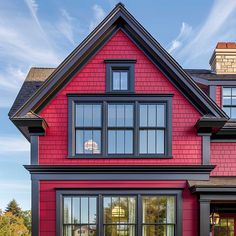 a red house with black trim and windows