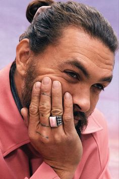 a close up of a person with a ring on his finger