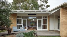 a house that has some plants in front of it