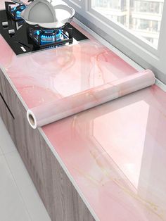 a kitchen counter with pink marble on it