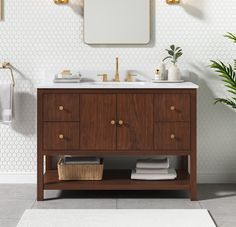 a bathroom with a sink, mirror and towel rack on the wall next to it