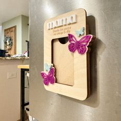 a refrigerator with magnets on the side and butterflies attached to it's door