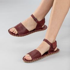 Step out in style and comfort with our Red Opened Toe Barefoot Sandals! Handmade with 100% natural leather, these sandals feature a natural leather upper and lining, and a water buffalo leather sole that's perfect for all-day wear. The "zero-drop" non-elevated heel ensures proper posture while the wide toe boxes give your toes enough room to spread and relax. To ensure the perfect fit, use our easy-to-follow size chart and measure your foot to find the right size. With next day shipping and free shipping to the USA, Canada, and Europe, you can have your Red Opened Toe Barefoot Sandals in no time. Plus, with our easy exchange and return policy, you can shop with confidence. Made in Turkey 100% Handmade 100% Natural Hand-Stitched Natural Leather Upper Natural Leather Lining Water Buffalo Lea Barefoot Sandals Women, Women's Slip Ons, Proper Posture, Water Buffalo, Barefoot Shoes, Buffalo Leather, Slipper Boots, Ballet Flat Shoes, Kids Boots