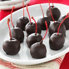 chocolate covered cherries on a white plate