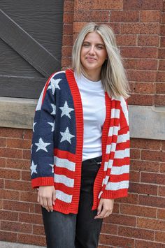 Introducing our American Flag Print Knit Cardigan, a statement piece that blends fashion with patriotism seamlessly. Crafted with care and attention to detail, this cardigan features a striking American flag print, showcasing the iconic stars and stripes in a tasteful design. Made from high-quality knit fabric, this cardigan offers both comfort and style. Its soft texture provides warmth and coziness, making it perfect for chilly evenings or breezy days. The relaxed fit and versatile design make Long Sleeve Flag Print Sweater For Fall, Fall Flag Print Long Sleeve Sweater, Fall Long Sleeve Flag Print Sweater, Americana Long Sleeve Sweater For Fall, Long Sleeve Americana Sweater For Fall, Americana Long Sleeve Winter Outerwear, Fall Americana Long Sleeve Sweater, Americana Style Long Sleeve Winter Outerwear, Patriotic Long Sleeve Winter Sweater