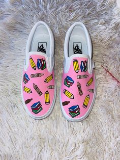 Hand painted teacher design on vans. Can change the background color(pink) to color preference and of course the name on the back. Just specify in the notes section when placing your order! ☺️ Teacher Vans, Teacher Shoes Painted, Custom Slip On Vans, Graduation Shirts For Family, Teacher Shoes, Vans Painted, Teacher Tee Shirts, Teacher Accessories, Painting Teacher