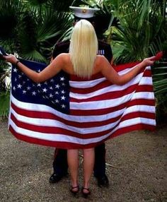 a man and woman holding an american flag