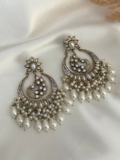 High quality kundan  work classic chandbali with pearl and faux american diamond detailing statement earrings, available in colors.  Lightweight  Dimensions- Earrings length- 3 inches  Style tip- Pair it with any beautiful traditional outfits  and flaunt with Unique style of collection from us. Perfect match for Festival and Traditional wear.  Take Care Tips-  Kee away from perfume, Hair spray and. Moisture.  Store in dry place , Ziplock bag or Airtight box.    Clean with dry cloth.  Jewellery i Temple Jewelry Style Chandbalis With Mirror Work For Party, Temple Jewelry Chandbalis With Mirror Work For Party, Festive Kundan Chandelier Earrings With Mirror Work, Party Kundan Chandbalis With Pearl Drop, Temple Jewelry Chandbali Danglers With Mirror Work, Kundan Chandbali Earrings With Gota Work, Party Chandbali Chandelier Earrings With Gota Work, Bollywood Chandbali Bridal Earrings With Mirror Work, Festive Chandbali Danglers With Mirror Work