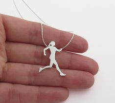 "Running women pendant necklace, handmade of sterling silver. A Running men necklace is also available in a link below. This beautiful runner pendant necklace is a part of my sports lovers jewelry collection. The pendant is 100% handmade by me. I saw each pendant by hand from a durable, solid sterling silver sheet, file it, solder the ring on the back, and give it a shiny finish. This necklace is a great gift idea for a runner or a coach. ✦ ITEM DETAILS ✦ Sterling silver pendant necklace. ✦ Meas Running Necklace, Marathon Gift, Silhouette Necklace, Sports Jewelry, Silver Jewelry Necklace, Coach Gifts, Sterling Silver Necklace Pendants, Lariat Necklace, Silver Pendant Necklace