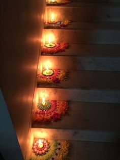 some candles are lit on the steps to decorate with flowers and garlands for diwaling