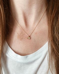 "This beautiful and delicate birthstone necklace is perfect for everyday wear. It has a 14/20 gold filled chain and features a tiny CZ birthstone on a 14k gold filled charm. Which means the color won't wear off and as always, all of our jewelry is nickel free. Pictured necklace length: 17\"	is_active	8619844	Apparel & Accessories > Jewelry > Necklaces	https://www.etsy.com/listing/939311607/tiny-birthstone-necklace-in-1420-gold	jewelry > necklaces > charm_necklaces	https://i.etsys Delicate Everyday Birthstone Necklace With Round Pendant, Dainty May Birthstone Charm Necklaces As Gift, Dainty Birthstone Pendant Necklaces, Dainty May Birthstone Charm Necklace As Gift, Delicate Birthstone Charm Necklace As Gift For Her, Dainty Hypoallergenic Birthstone Necklace For Gift, Delicate Birthstone Pendant Necklace For Gift, Dainty Necklace For Her With May Birthstone, Delicate May Birthstone Necklaces For Her